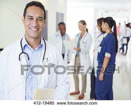 Doctor smiling in hospital hallway View Large Photo Image Stock Photography - Doctor smiling in hospital hallway. Fotosearch