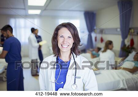 Doctor smiling in hospital room View Large Photo Image Stock Photo - Doctor smiling in hospital room. Fotosearch