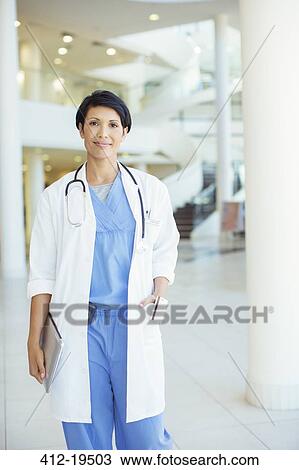 Doctor smiling in hospital View Large Photo Image Stock Image - Doctor smiling in hospital. Fotosearch