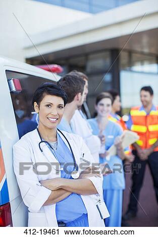 Doctor smiling outside hospital View Large Photo Image Stock Image - Doctor smiling outside hospital. Fotosearch