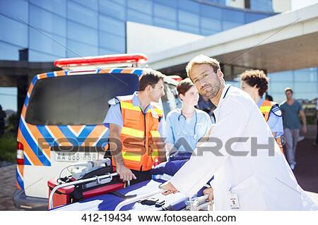 Doctor with paramedics outside hospital View Large Photo Image Picture - Doctor with paramedics outside hospital. Fotosearch