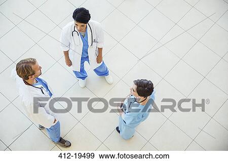 Doctors and nurse talking in hospital View Large Photo Image Stock Photo - Doctors and nurse talking in hospital. Fotosearch