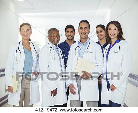 Doctors and nurses smiling in hospital hallway View Large Photo Image Stock Image - Doctors and nurses smiling in hospital hallway. Fotosearch