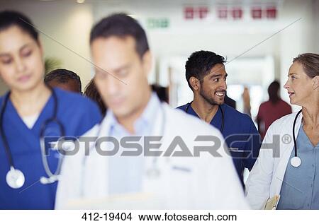 Doctors and nurses talking in hospital hallway View Large Photo Image Picture - Doctors and nurses talking in hospital hallway. Fotosearch