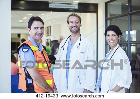 Doctors and paramedic smiling outside hospital View Large Photo Image Stock Image - Doctors and paramedic smiling outside hospital. Fotosearch