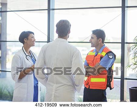 Stock Photo - Doctors and paramedic talking in hospital. Fotosearch
