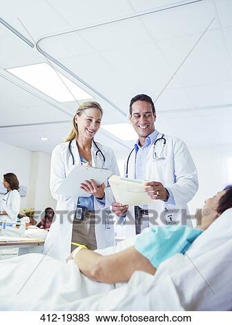 Doctors examining patient in hospital room View Large Photo Image Stock Image - Doctors examining patient in hospital room. Fotosearch