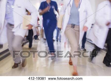 Doctors rushing in hospital hallway View Large Photo Image Stock Image - Doctors rushing in hospital hallway. Fotosearch