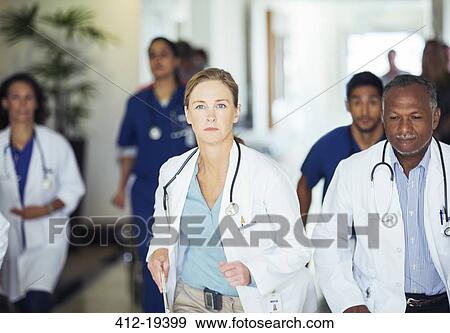 Doctors rushing in hospital hallway View Large Photo Image Stock Photo - Doctors rushing in hospital hallway. Fotosearch