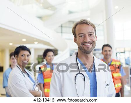 Stock Image - Doctors smiling in hospital. Fotosearch