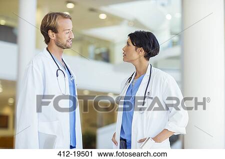 Doctors talking in hospital View Large Photo Image Stock Image - Doctors talking in hospital. Fotosearch