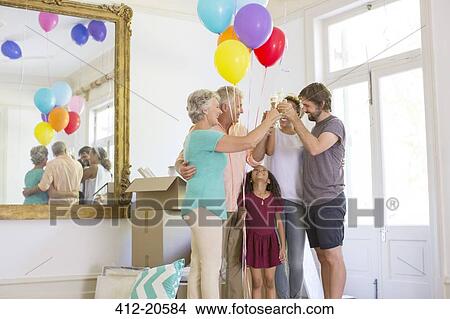 Family celebrating with drinks and balloons View Large Photo Image Picture - Family celebrating with drinks and balloons. Fotosearch