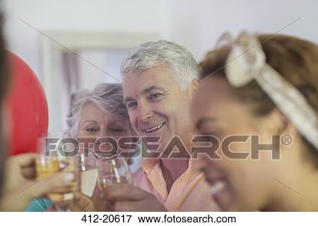 Stock Photo - Family celebration with drinks . Fotosearch