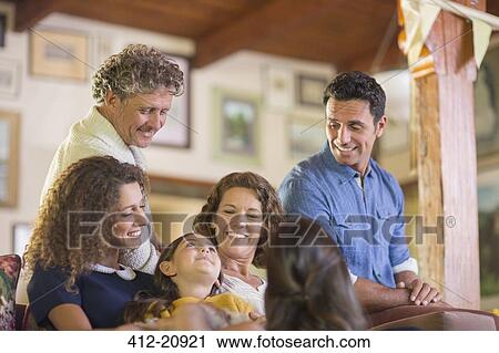 Family gathered on the couch together View Large Photo Image Stock Image - Family gathered on the couch together. Fotosearch