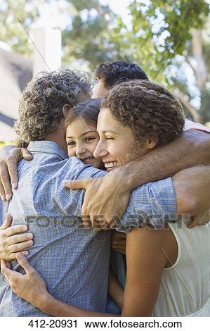 Family hugging outdoors View Large Photo Image Stock Image - Family hugging outdoors . Fotosearch