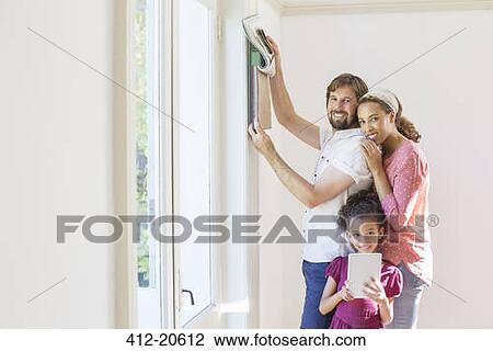 Stock Image - Family looking through fabric swatches together . Fotosearch