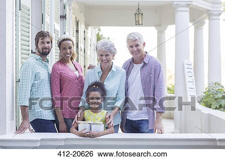 Stock Photograph - Family smiling on porch together . Fotosearch