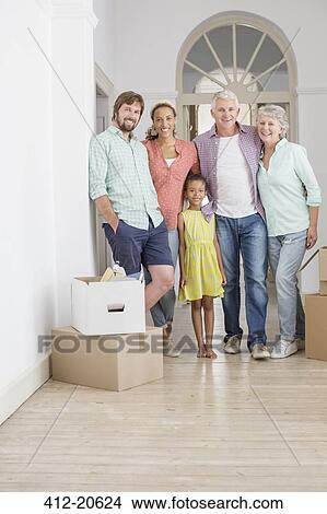 Family smiling together in living space View Large Photo Image Picture - Family smiling together in living space. Fotosearch