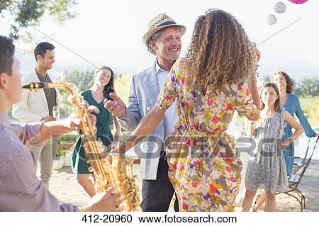 Stock Image - Father and daughter dancing together. Fotosearch