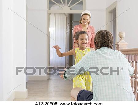 Father and daughter embracing in living space View Large Photo Image Stock Photo - Father and daughter embracing in living space. Fotosearch
