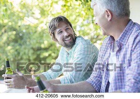 Father and son drinking outdoors View Large Photo Image Stock Photography - Father and son drinking outdoors. Fotosearch