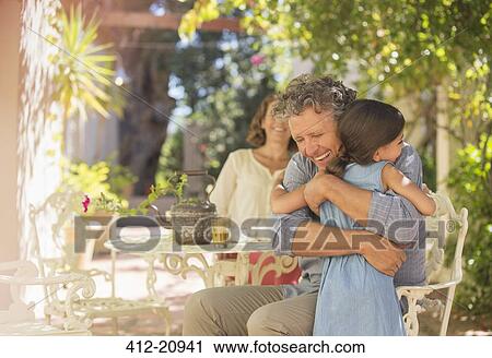 Grandfather and granddaughter hugging outdoors View Large Photo Image Stock Image - Grandfather and granddaughter hugging outdoors. Fotosearch