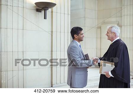 Judge and lawyer shaking hands in courthouse View Large Photo Image Stock Photo - Judge and lawyer shaking hands in courthouse. Fotosearch