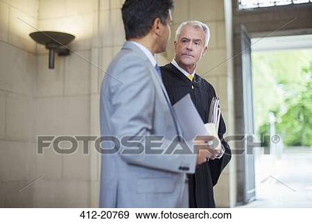 Judge and lawyer talking in courthouse View Large Photo Image Stock Photo - Judge and lawyer talking in courthouse. Fotosearch