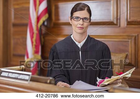 Judge examining documents at judges bench in court View Large Photo Image Stock Photograph - Judge examining documents at judges bench in court. Fotosearch