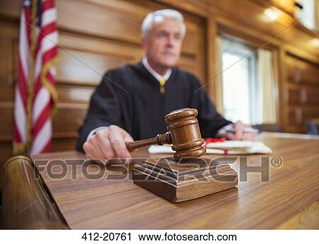 Judge holding gavel in court View Large Photo Image Stock Image - Judge holding gavel in court . Fotosearch