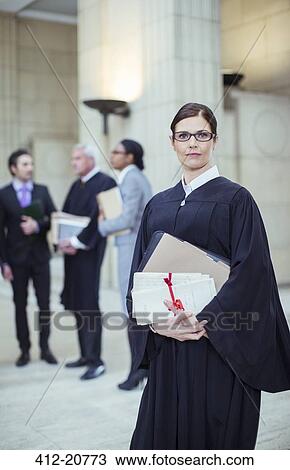 Judge holding legal documents in courthouse View Large Photo Image Stock Image - Judge holding legal documents in courthouse. Fotosearch