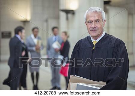 Judge holding legal documents in courthouse View Large Photo Image Stock Photo - Judge holding legal documents in courthouse. Fotosearch