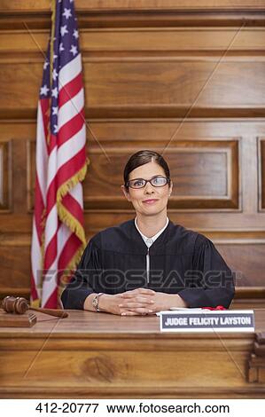 Stock Photo - Judge sitting at judges bench in court. Fotosearch