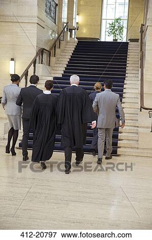 Judges and lawyers walking through courthouse together View Large Photo Image Stock Photo - Judges and lawyers walking through courthouse together. Fotosearch