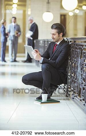 Lawyer doing work on digital tablet in courthouse View Large Photo Image Stock Image - Lawyer doing work on digital tablet in courthouse. Fotosearch