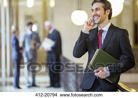 Lawyer talking on cell phone in courthouse View Large Photo Image Picture - Lawyer talking on cell phone in courthouse. Fotosearch