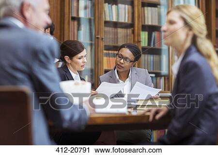 Lawyers examining documents in chambers View Large Photo Image Stock Image - Lawyers examining documents in chambers. Fotosearch