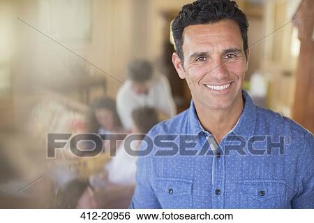 Stock Photograph - Man smiling with family near . Fotosearch