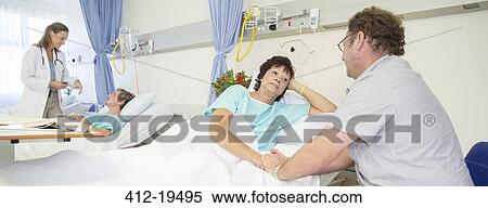 Man talking to wife in hospital room View Large Photo Image Stock Photography - Man talking to wife in hospital room. Fotosearch