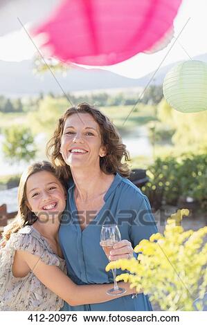 Mother and daughter hugging at family picnic View Large Photo Image Stock Photograph - Mother and daughter hugging at family picnic. Fotosearch