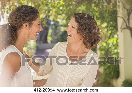Mother and daughter laughing together View Large Photo Image Picture - Mother and daughter laughing together. Fotosearch