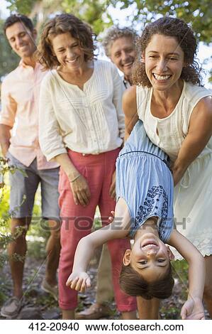 Mother and daughter playing with family outdoors View Large Photo Image Stock Image - Mother and daughter playing with family outdoors. Fotosearch
