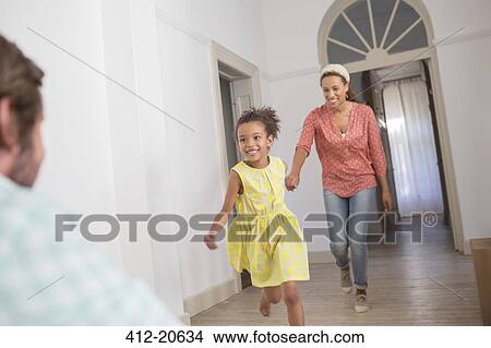 Picture - Mother and daughter running towards father. Fotosearch