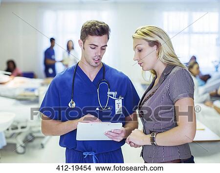 Nurse and patient reading medical charts in hospital View Large Photo Image Picture - Nurse and patient reading medical charts in hospital. Fotosearch
