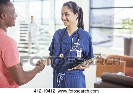 Nurse and patient shaking hands in hospital View Large Photo Image Stock Image - Nurse and patient shaking hands in hospital. Fotosearch