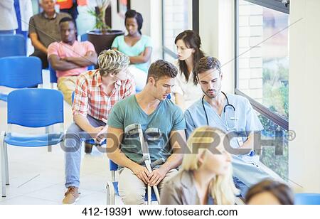 Stock Image - Nurse and patient talking in hospital. Fotosearch