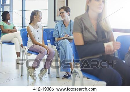 Stock Photography - Nurse and patient talking in hospital. Fotosearch