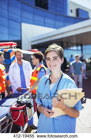 Nurse smiling outside hospital View Large Photo Image Stock Photography - Nurse smiling outside hospital. Fotosearch