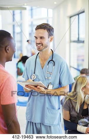 Stock Image - Nurse talking to patient in hospital. Fotosearch