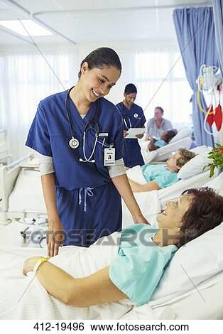 Stock Photograph - Nurse talking to patient in hospital room. Fotosearch